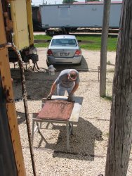 Chuck uses the old door face as a template for the replacement cover - Photo by Pauline Trabert