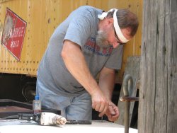 Chuck drilling and tapping holes for the new door face - Photo by Pauline Trabert