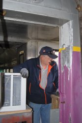 Ray Mormann helping to remove air conditioners - Photo by Shelly Vanderschaegen