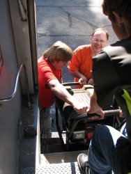 Mark Gellman, Warren Newhauser and his helper Fred lift a faulty generator from the vestibule for repair - Photo by Pauline Trabert