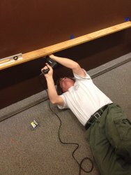 Mark Gellman installing a shelf - Photo by Michael McCraren 