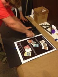 Mark is cutting the graphic off the larger backing sheet - Photo by Michael McCraren