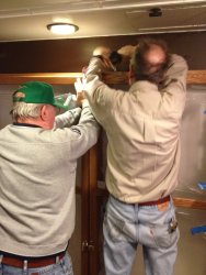 Buzz and Kevin attaching the cabinet to the wall in Exhibit Car 1 - Photo by Michael McCraren 