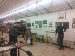 Frank, Joel, and an unidentified person discuss the new training machine - Photo by Brian LaKemper