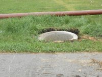 Concrete pipe "bubbled down" below grade.