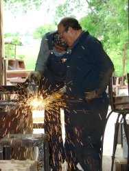 Steam Team members weld support brackets on the ladder for the drop pit