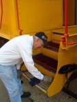 08.12.09 - BILL LEIDER IS PAINTING THE GRATING ON THE STEPS OF THE CABOOSE.  IT IS A SLOW, MESSY JOB TO COMPLETE, AS IT IS HARD TO COVER EACH PART OF THE GRATING WITHOUT DRIPPING.