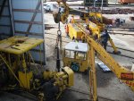 Wes on the crane lifts the engine while Warren guides it