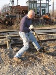 Frank loosening ballast around the tie to be removed