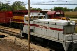 ComEd 15 switches on the west station lead while the freight train rolls east by Spaulding Tower