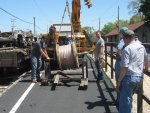 Placing the new wire in position to begin feeding it through the hangers