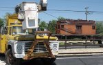 Bucket truck and line car at the depot