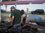 09.09.09 - MANY HANDS TRY TO GET THE JOURNAL BRASS INTO PLACE ON THE CHICAGO SURFACE LINES 3142, AS THE REBUILT MOTOR IS INSTALLED.  SINCE THERE IS NO ROOM TO GET INSIDE THE TRUCK, MIKE IS LAYING ON THE LIFT TRUCK FORK TO TRY AND HELP.