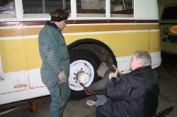 Richard, Bill and Wally in the midst of mounting the street-side rear tires.  02/19/2011