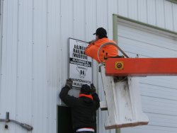 Putting up the new B&G Dept sign (03/12/2005).