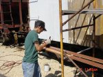 09.07.08 - JOHN BALETTO IS PRIMING THE BACK AND EDGES OF THE NEW SIDING PRIOR TO APLICATION TO THE CAR.