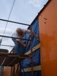 08.05.09 - DICK CUBBAGE IS NAILING A SIDING BOARD INTO PLACE.