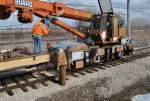 Jeron Glander and Patrick Shea prepare to cut off the crane to pull a bundle of ties off the flatcar.  Tom Hunter is running the crane. 3-13-11