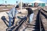 After lifting comes gun tamping, as the inspector checks the work