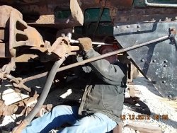 Angle cock and air line pipe installed, now Paul is tightening bolt that secures carrier iron to coach body.    12-12-12  
