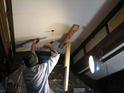 Buzz Morrisette setting a nail in the ceiling. 