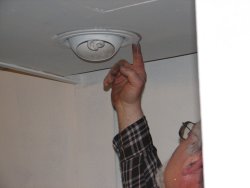 Here Mike seals the edged of the light fixture.