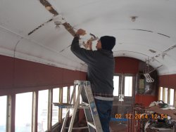  Lincoln's birthday..  Here's Gary scraping paint of ceiling in the cold We don't have a warm area but the little crew keeps on working     DSCN0727
