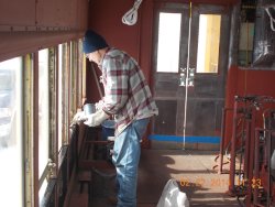 Early in the am Gary is painting the metal window sill.  Its cold.2-22-14   DSCN0730