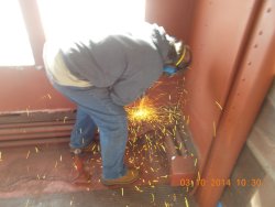 March 10 14 Gary is grinding off more old screw so that we can remove the rusted piece of steel  DSCN0754