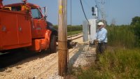 Bob Olson operating electric capstain used to raise transformer.