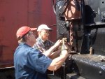 06.18.08 - VICTOR HUMPHREYS AND JOHN  FAULHABER INSTALL THE RIVET AND COTTER PIN SECURING THE CHAIN TO THE HANDBRAKE ROD.