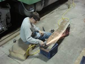 Dan S working on electrical cabinet door 