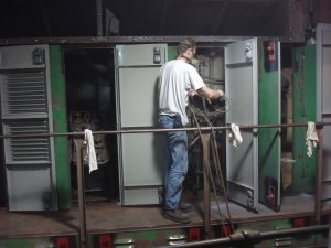 Jamie painting final coat of gray on engine room doors