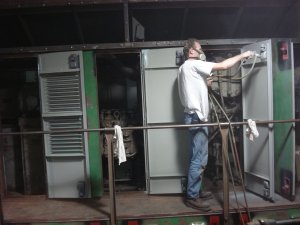 Jamie painting final coat of gray on engine room doors