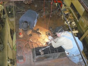 Kyle DA sanding and Roger wire wheeling the roof where the air tanks will go.