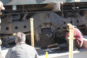 Jamie checks the motor nose supports to align them with the truck supports to slide the nose pack back into place.