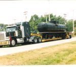 THE RESTORED CAR ARRIVES ON OLSEN ROAD ON SILK ROADS TRANSPORTS SPECIAL TRAILER.