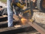 Tom H. cutting rail in Yard 10 for the barn  Oct 2004