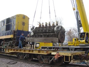 The rare 12 cylinder Winton engine is lifted off the flat car 1st in preparation to unloading the 543. It would be later loaded on IRM's DODX flat car to be taken back to the property.